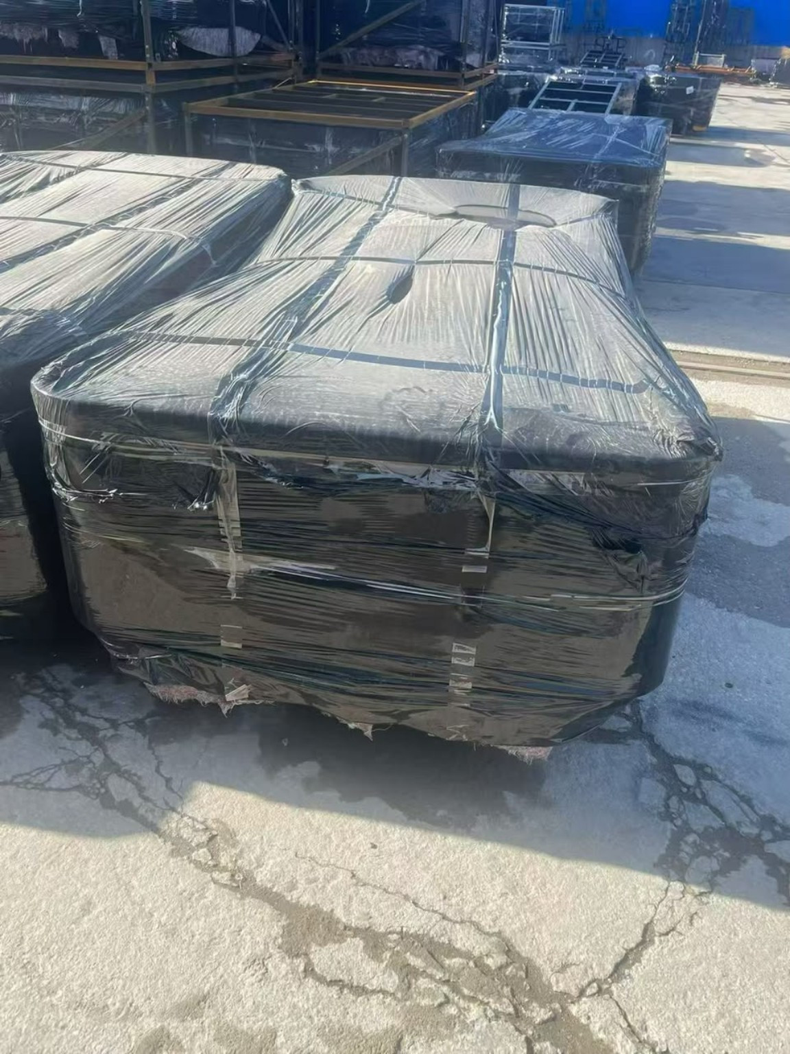 Large cargo secured with wrapping and straps